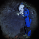 A crew member investigating rock within a Mauna Loa lava tube.